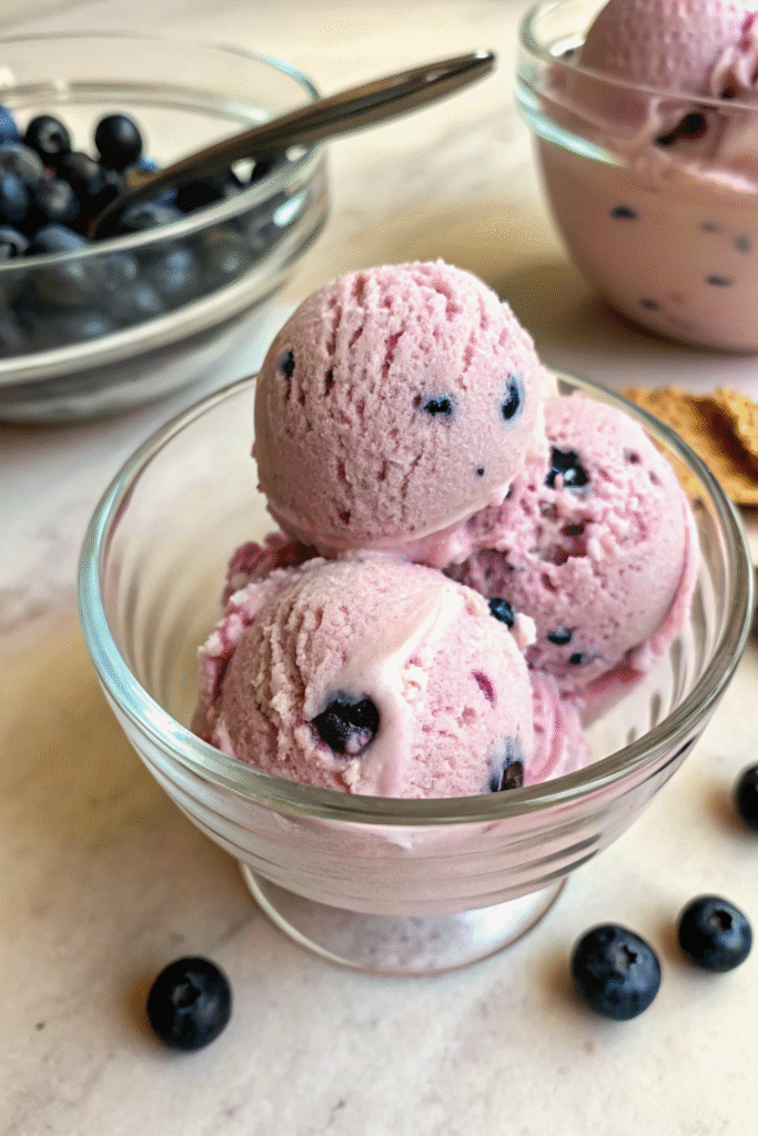 Bowl of blueberry vegan ice cream scoops ready to serve.