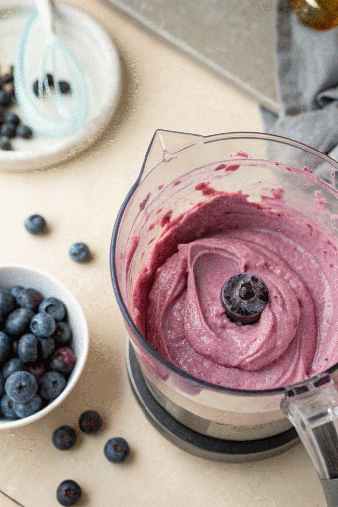 Smooth blueberry ice cream mixture in a blender.
