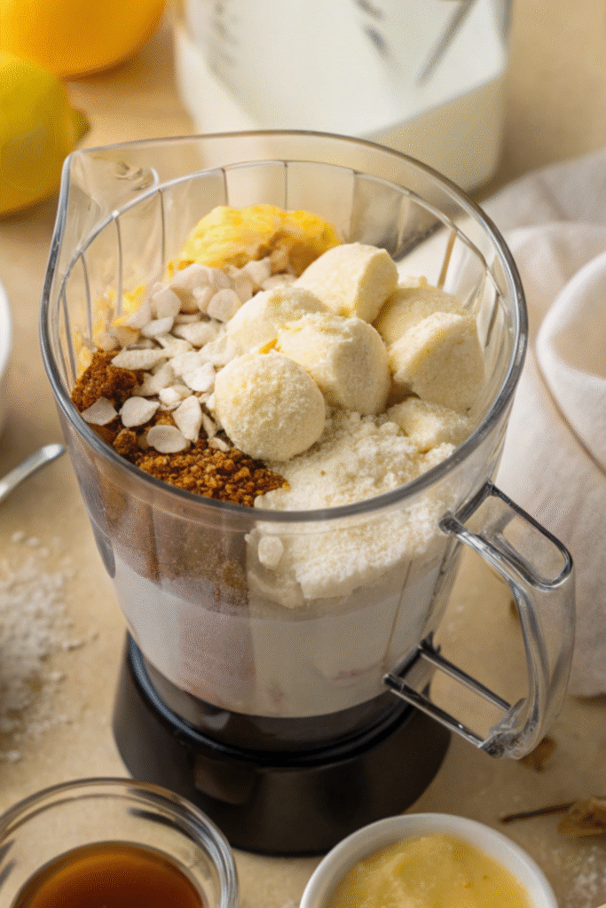 Frozen bananas, sweeteners, and ingredients in a blender ready to mix.