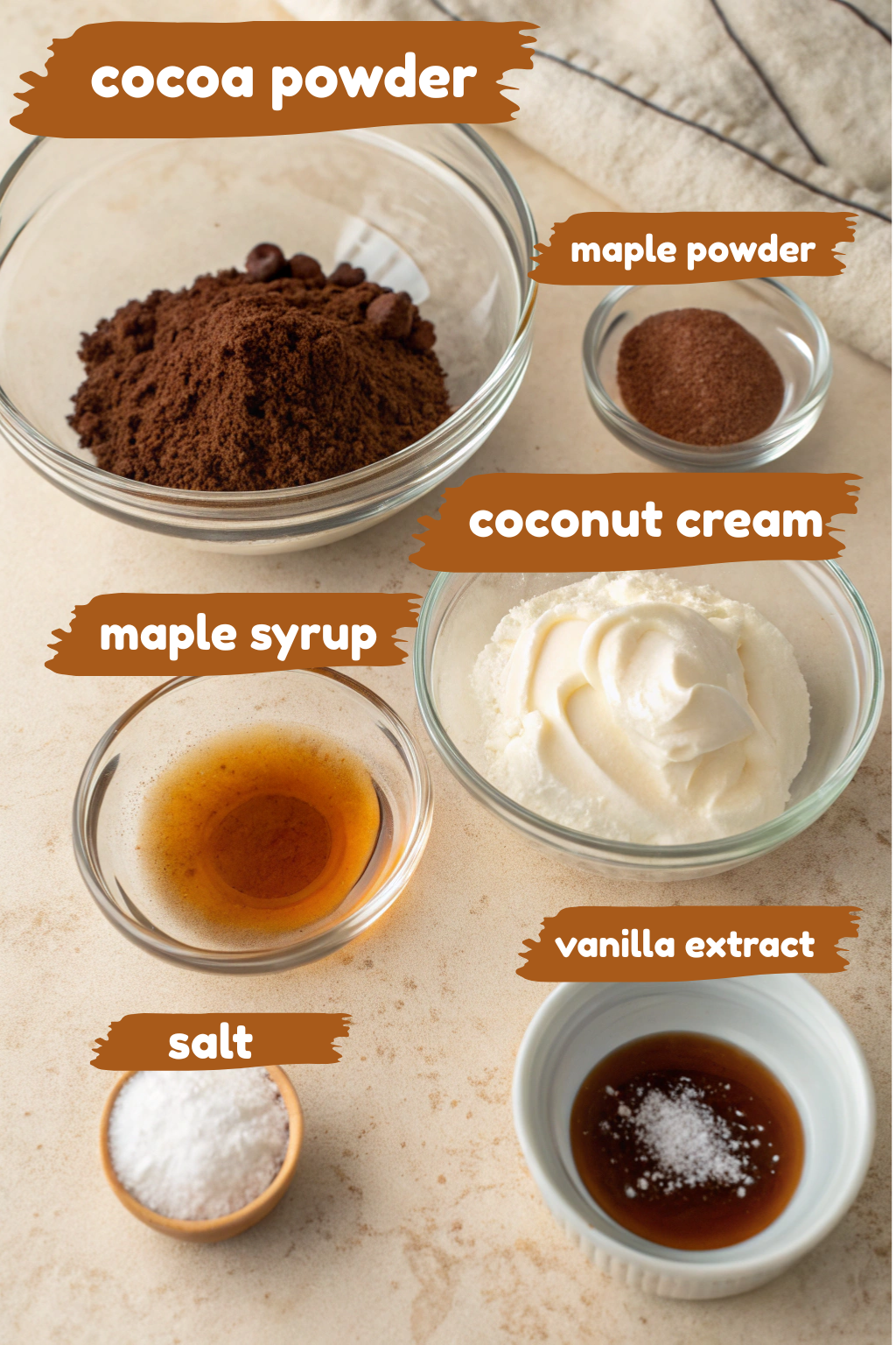 Flat lay of ingredients for vegan chocolate coconut ice cream including cocoa powder, coconut milk, maple syrup, vanilla extract, and salt
