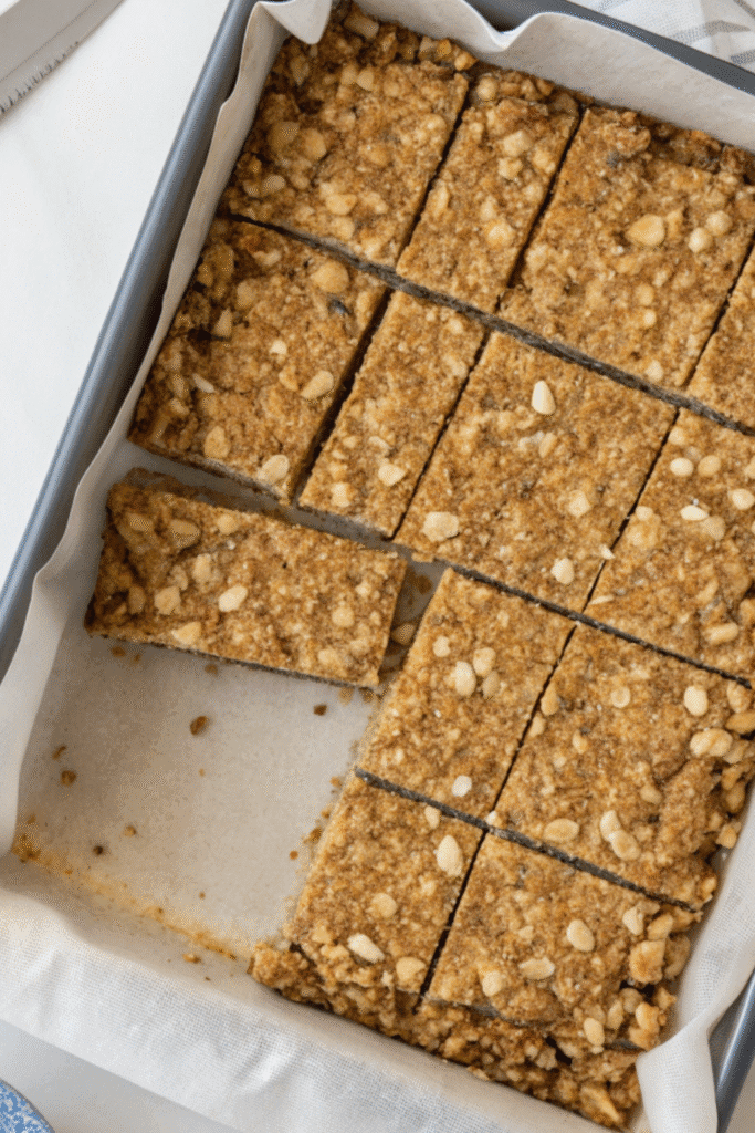 Granola protein bars recipe shown sliced into neat bars after chilling in a baking pan.