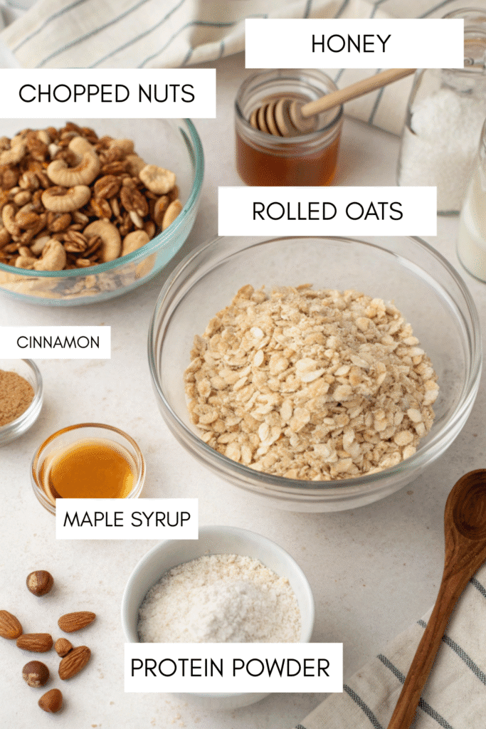 Ingredients for homemade protein granola bars with oats, nuts, protein powder, honey, and maple syrup.