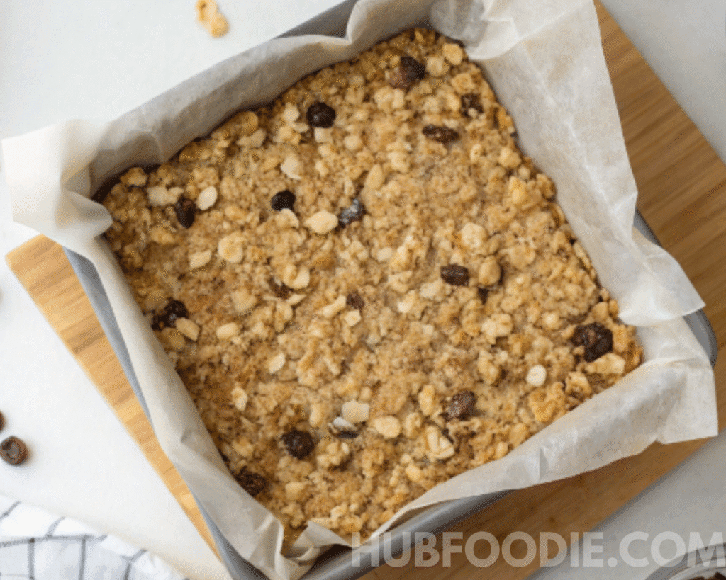 Nut Free Granola Bars mixture pressed into a parchment-lined pan before chilling or baking.