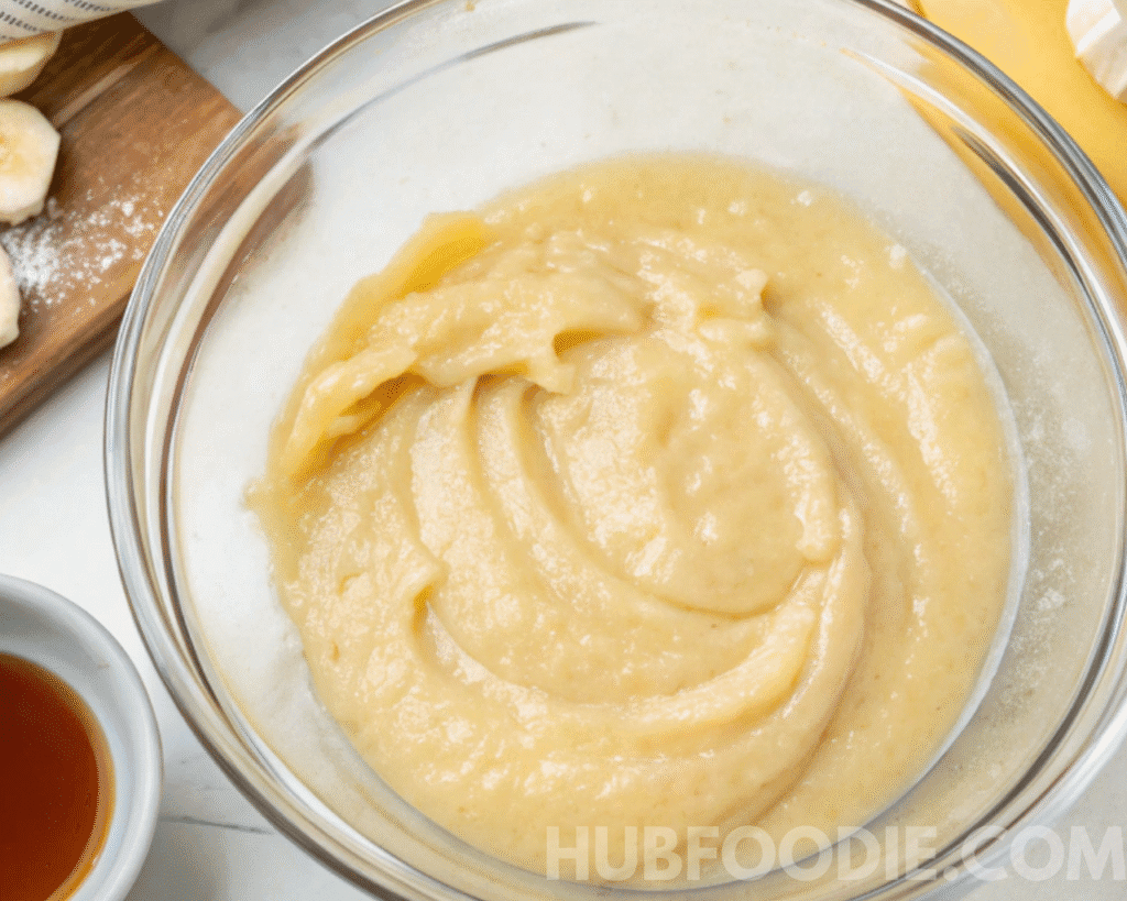 Bowl of mashed banana mixture being prepared as the wet base for nut free granola bars.