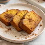 lemon squash bread recipe 38 Acorn squash bread slices on a speckled plate with scattered spice crumbs.