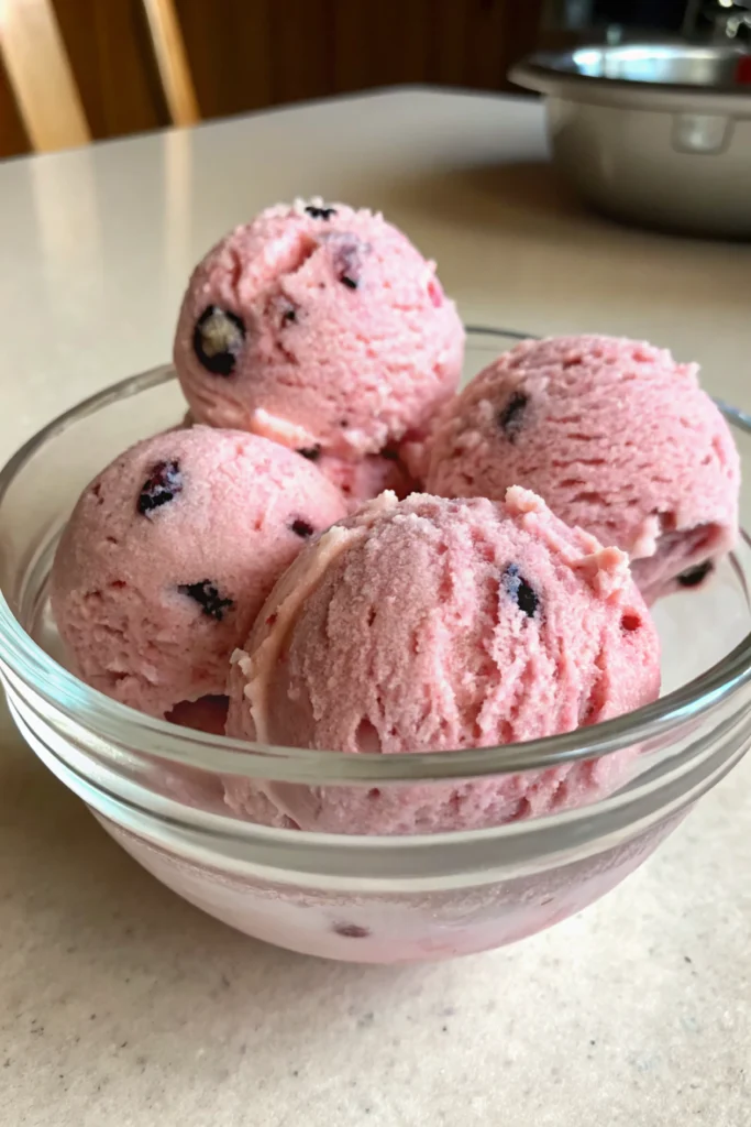 Vegan Berry Ice Cream 22 Scoops of Vegan Berry Ice Cream in a glass bowl on a light countertop