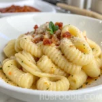 Gnocchi noodles in creamy parmesan sauce, topped with grated cheese and crispy bits.
