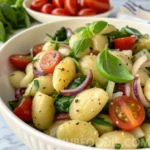 Gnocchi Pasta Salad 62 Gnocchi pasta salad with cherry tomatoes, red onion, spinach, and basil.
