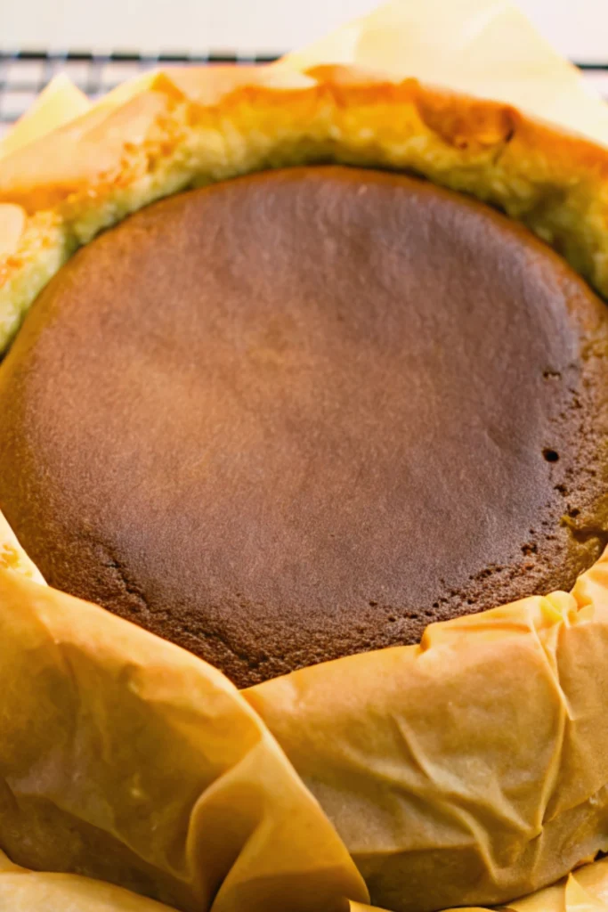 Matcha Basque Cheesecake 24 Freshly baked matcha Basque cheesecake cooling in parchment paper with a caramelized top.