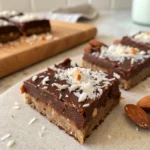 Vegan Chocolate Coconut Bars 20 Close-up of Vegan Chocolate Coconut Bars with almond crust and coconut flakes